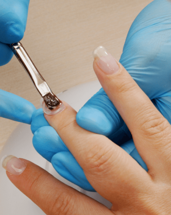 Foto de uma manicure fazendo extensão em uma cliente, representando o dia a dia do mercado de unhas.