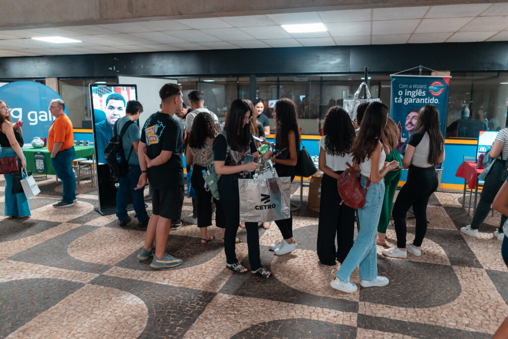 Fotografia de estudantes no estande da Cetro na Feira da Empregabilidade do UNISAGRADO.