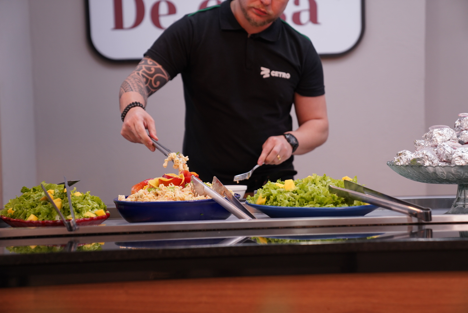 Fotografia dos colaboradores se servindo durante o almoço temático do Festival de Primavera.